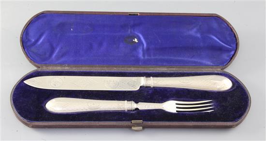 A cased Victorian silver carving knife and fork set, by Martin, Hall & Co, Sheffield, 1871.